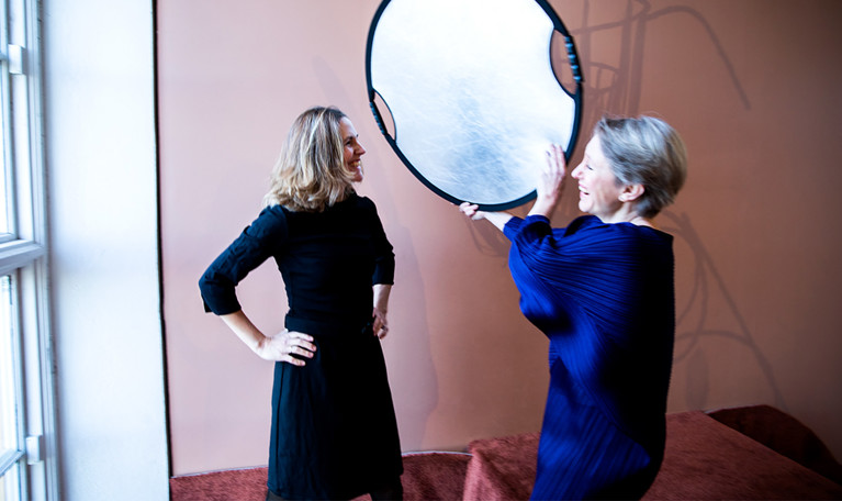 Portrait of two women, laughing. Black and white photo.