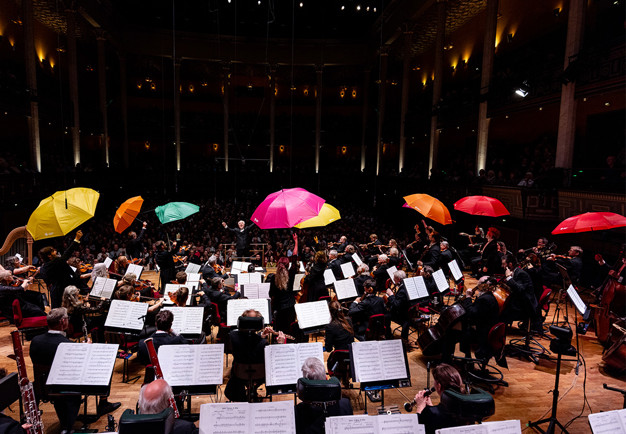 Musiker håller i paraplyer. Fotografi.
