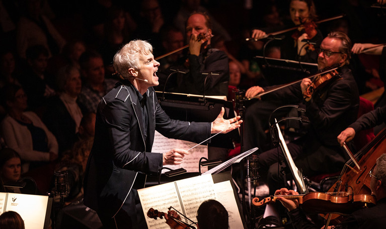Man conducting an orchestra. Photo