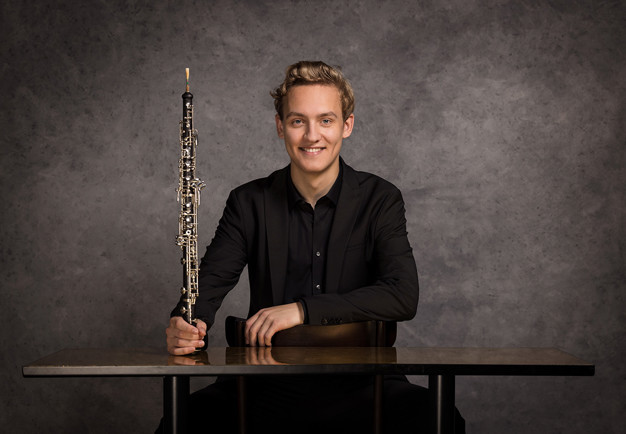 Photo of a woman in dark hair and clothes. Picture