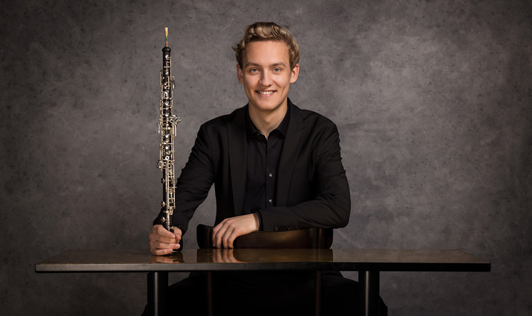 Photo of a woman in dark hair and clothes. Picture