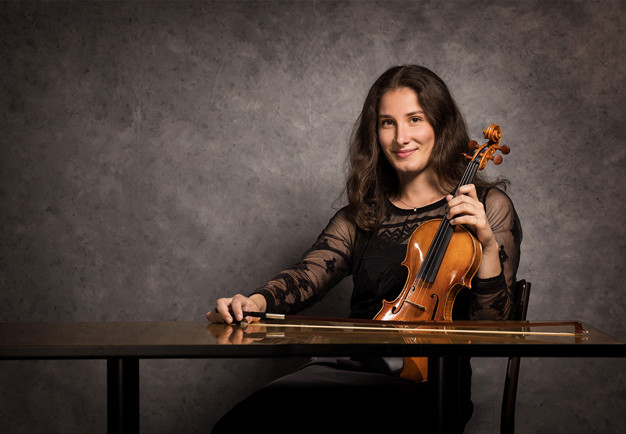 Picture of a woman with glasses and long hair. Photo
