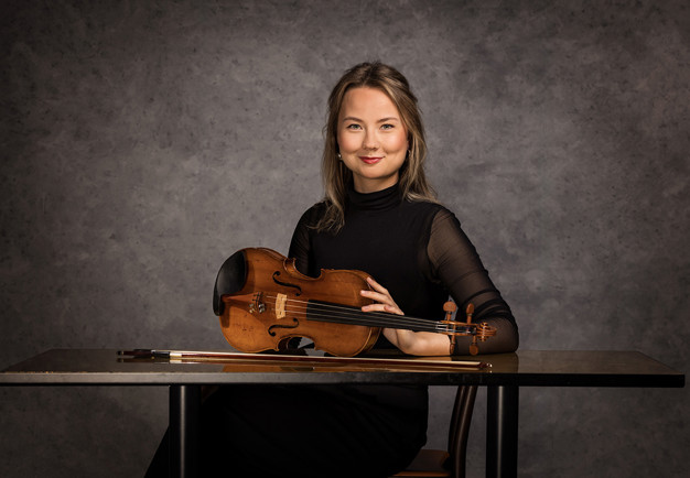Photo of  a man with short hair and black clothes. Photo