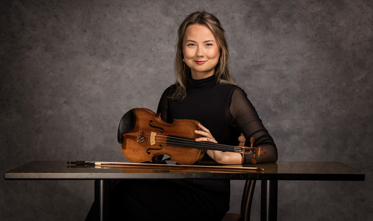 Photo of  a man with short hair and black clothes. Photo